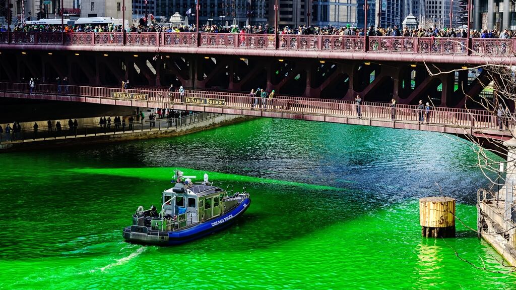 A police boat on the Chicago river dyed green for St Patrick’s Day. Photograph: iStock/Steve Geer