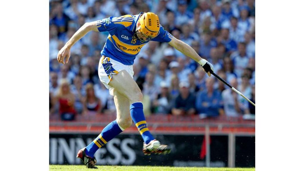 Lar Corbett kicks the sliotar past Clinton Hennessy for the first of Tipperary’s goals. Photograph: Lorraine O'Sullivan/Inpho
