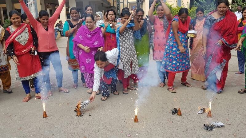Women burn crackers after all four men accused in the rape and murder of a Hyderabad veterinarian were killed by police officers. Photograph: EPA/