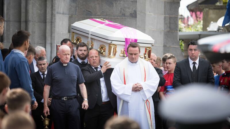 Mourners carry Shay Moloney on his final journey as Ennis Rugby Club members provide a guard of honour at the funeral in Ennis on Monday morning. Photograph: Eamon Ward