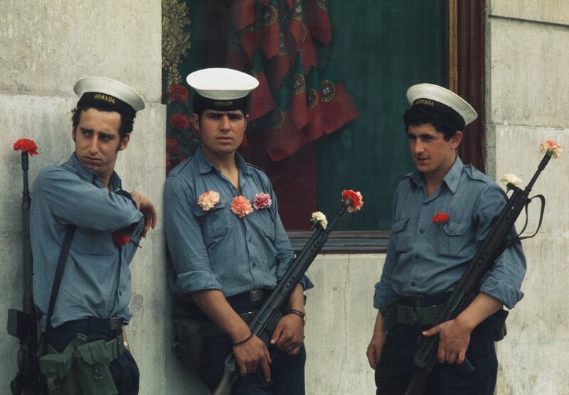 Portuguese soldiers with carnations, symbol of their country's revolution against the right-wing Estado Novo regime, in Lisbon in 1974. Photograph: UPI/Bettmann/Getty