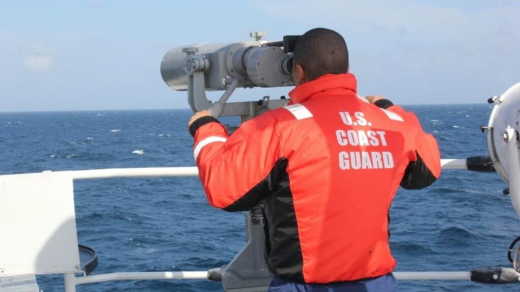 A crew member of the US Coast Guard Cutter Vigorous searches for crew members of the sailing vessel Cheeki Rafiki,  off Cape Cod earlier this week. Photograph: US Coast Guard/Reuters