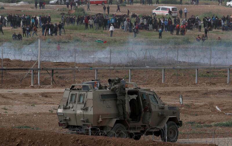 Palestinian protesters from Gaza Strip and Israeli soldiers clash as soldiers tae up positions at the security fence facing the Gaza neighborhood of Shjaaia on March 30th. Photograph: Atef Safadi/EPA
