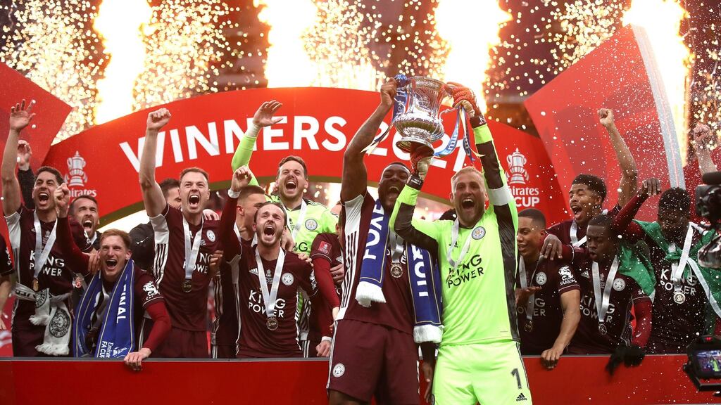 Kasper Schmeichel and Wes Morgan of Leicester City lift the FA Cup at Wembley. Photograph: Nick Potts/Getty Images