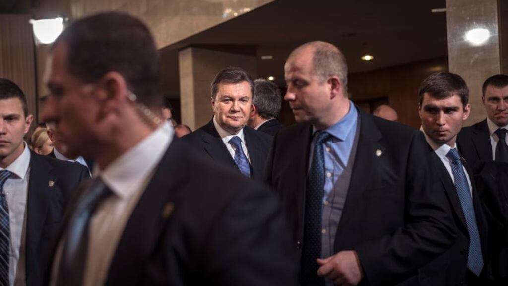 Ukraine’s president Viktor Yanukovich, centre rear, leaves a meeting with opposition leaders in Kiev on Friday. The meeting took place within hours of Ukraine’s richest man, Rinat Akhmetov, breaking his silence over the political crisis and calling on all sides to “sit at the negotiating table and take decisions that will make us proud”. Photograph: Sergey Ponomarev/The New York Times