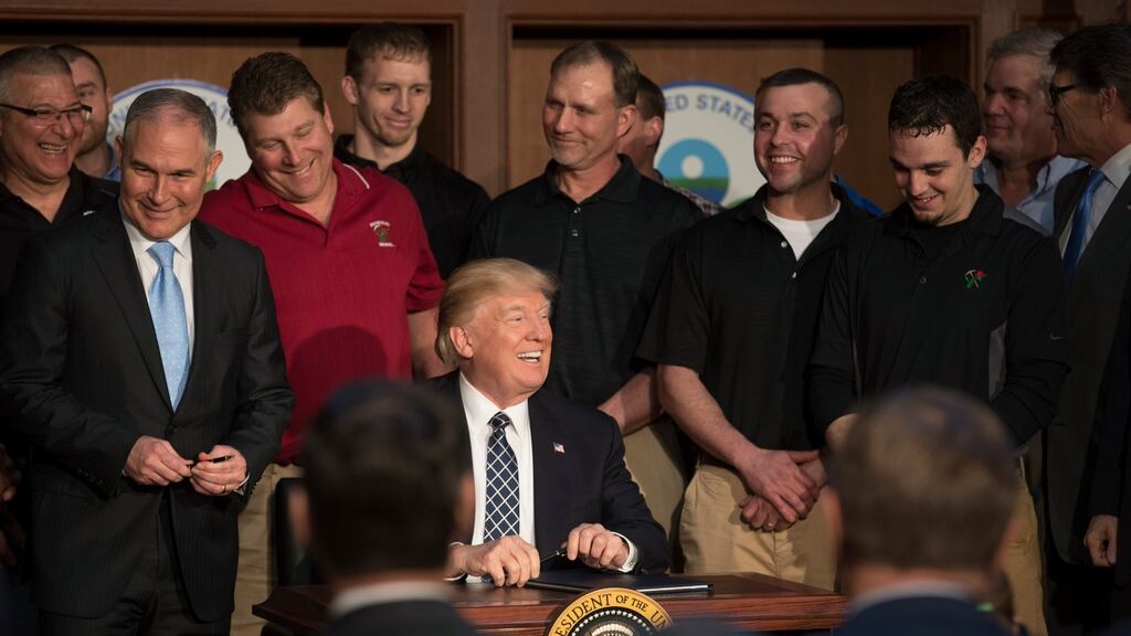 Climate change: President Trump signs an executive order intended to roll back most of President Obama’s climate-change legacy. Photograph: Stephen Crowley/New York Times