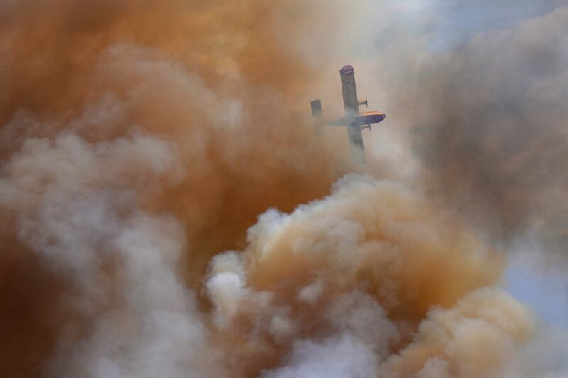 A firefighting plane above a wildfire in Zamora, Spain. Photograph: Cesar Manso/AFP/Getty