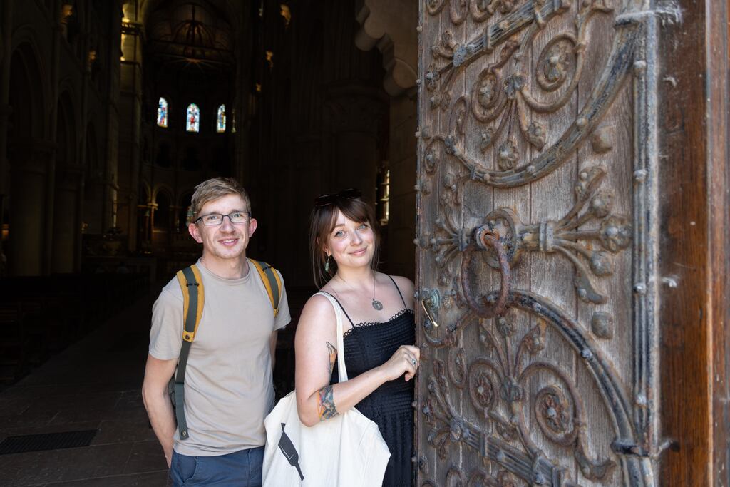 Behind the neo-Gothic doors of St Fin Barre’s Cathedral in Cork are Maik Barry and Eileen Segatz. More than 30 buildings in the city will be open to the public as part of the Open Day initiative during Heritage Week. Photograph: Darragh Kane
