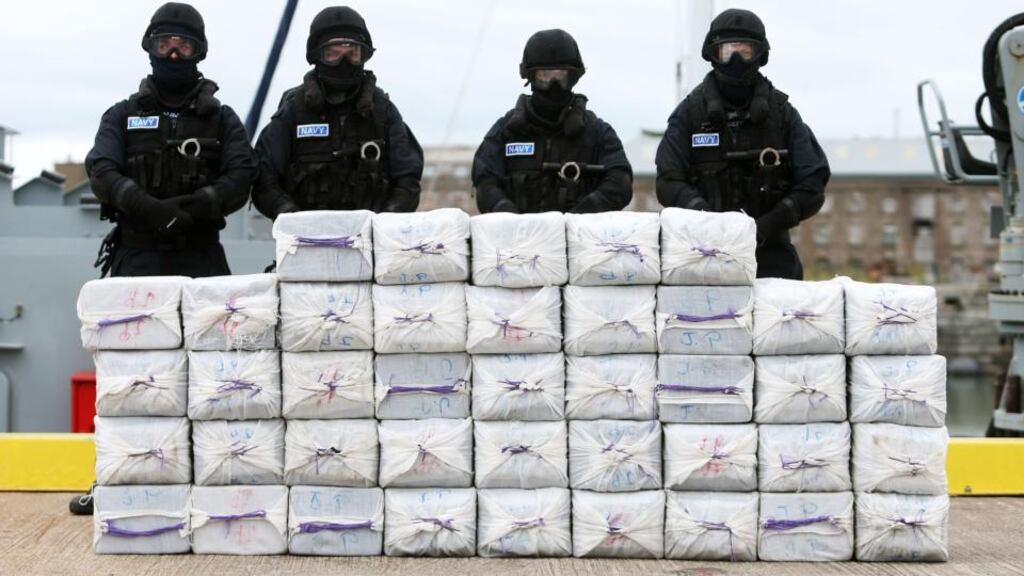 File photograph showing members of the Irish navy standing behind what is believed to be about €300 million worth of cocaine detained on the Makayabella yacht off the coast of Cork. Three men have been sentenced for  their part in the drug smuggling operation. File photograph: Brian Lawless/PA Wire