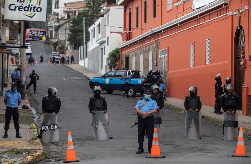 Officers from the Nicaraguan police and riot police forces at the entrance of Bishop Rolando Álvarez’s church, in Matagalpa, Nicaragua. Photograph: Inti Ocón/The New York Times