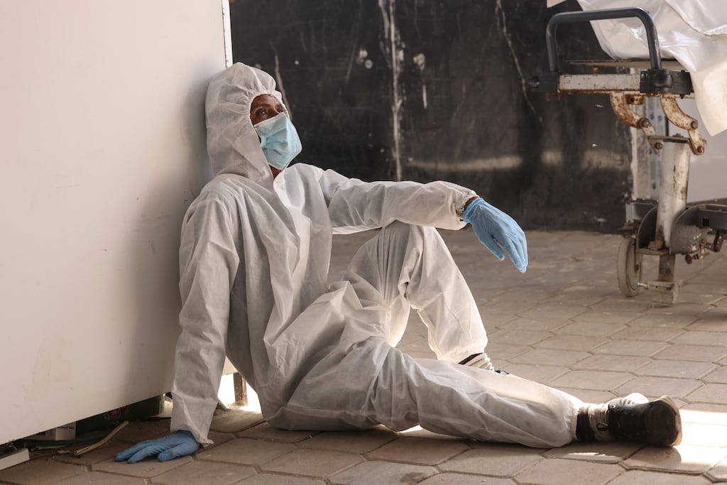 An employee of the Nasser Medical Complex rests after the unloading of body bags containing the 30 corpses of Palestinian prisoners detained by Israel and released as part of the hostage exchange deal, in Khan Yunis, in the southern Gaza Strip, on Friday. Photograph: AFP via Getty Images
