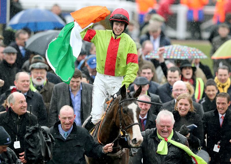 Bryan Cooper flies the tricolour after victory aboard Our Conor in the 2013 JCB Triumph Hurdle at Cheltenham. No one's waving flags any more because it doesn't feel right. Photograph: Dan Sheridan/Inpho