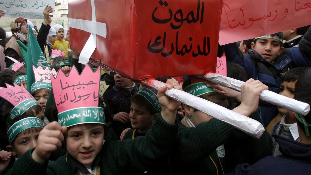 Children in the West Bank city of Hebron in 2005 with a mock coffin wrapped with a Danish flag that reads, in Arabic, “Death to Denmark”. Photograph: AFP/Getty Images