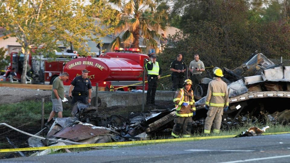 Emergency crews look over the wreckage at the scene on Interstate 5 near Highway 32 near Orland, California. Photograph: Greg Barnette/Record Searchlight/ Reuters