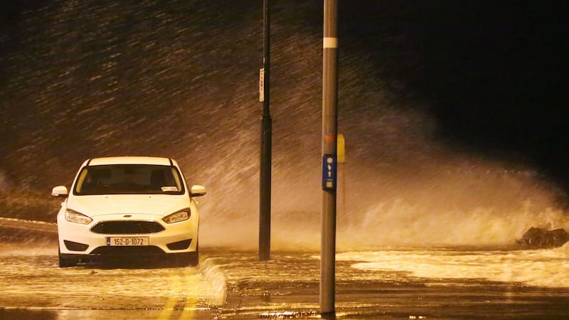 A parked car is seen at Salthill in Galway as waves crash over the promenade. Photograph: PA