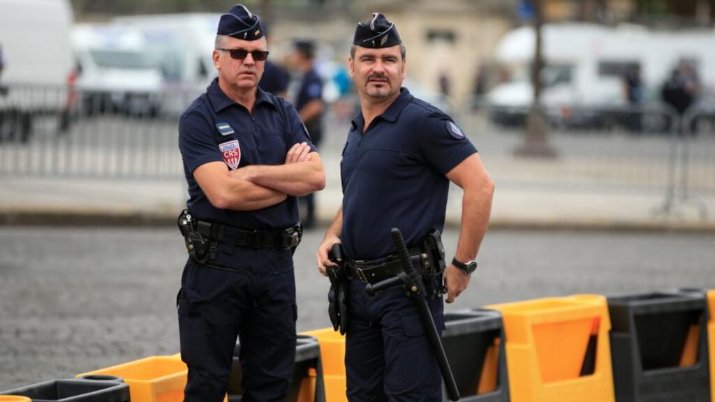 Police stand by barriers by the Champs-Elysees in Paris, France where the final stage of the Tour de France is due to finish on Sunday.