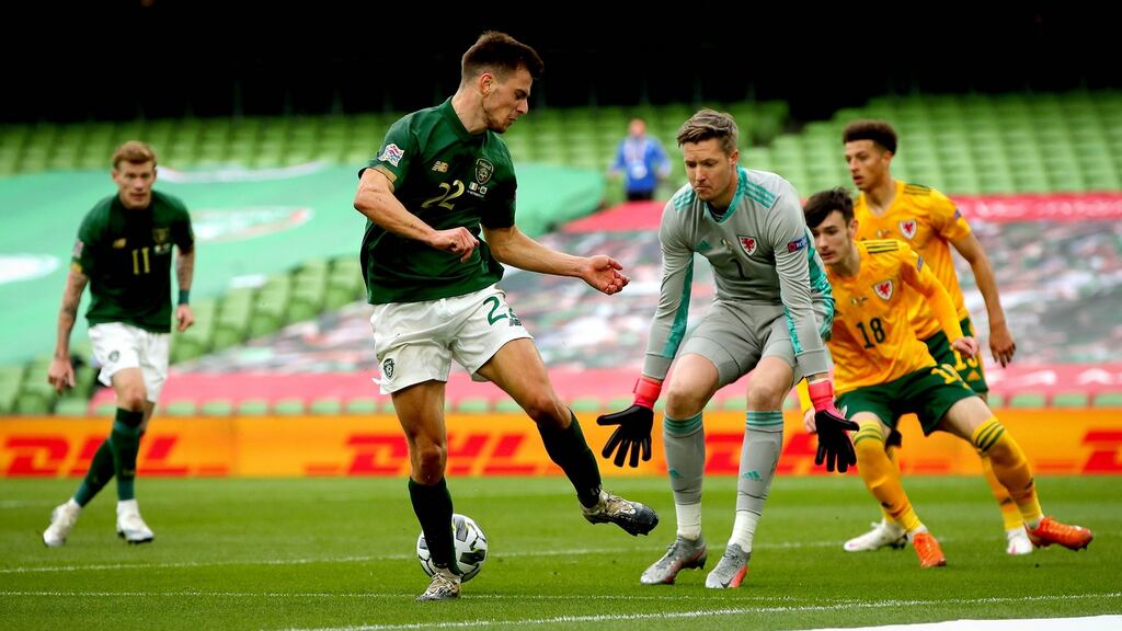 Ireland’s Jayson Molumby attempts to get on the end of a cross in front of Wales goalkeeper Wayne Hennessy. Photograph: Inpho