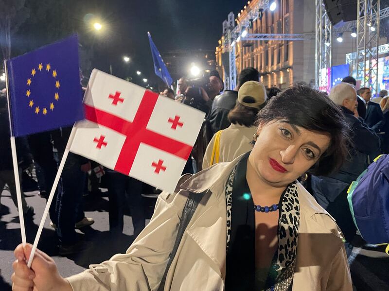 Sofia Kilasonia holds Georgia and EU flags at a rally in Tbilisi in favour of the Black Sea state's accession to the bloc. Photograph: Daniel McLaughlin