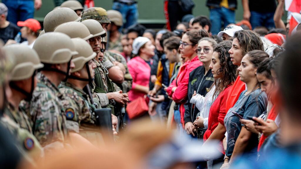 Female protesters stand in  line before Lebanese  soldiers during  the seventh day of protests in cities and towns across the country. Photograph:  Joseph Eid/AFP via Getty Images