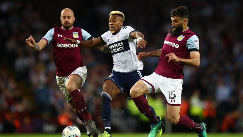 Adama Traore is challenged by Aston Villa’s Alan Hutton and Mile Jedinak. Photograph: Clive Mason/Getty