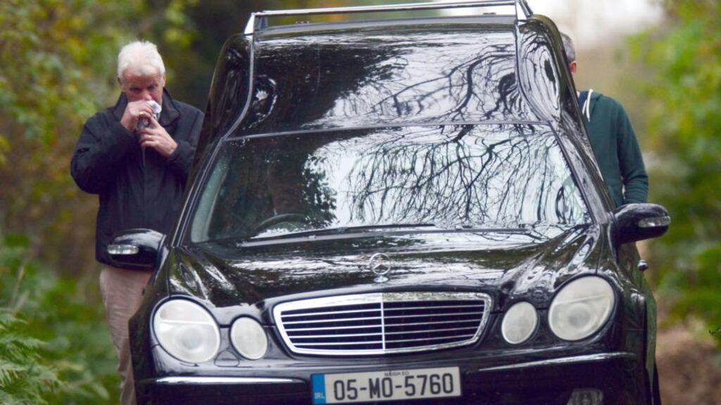 The bodies of Kitty and Tom Fitzgerald are removed from their home, accompanied by Tom’s brother Vincent. Photograph: Paul Mealey