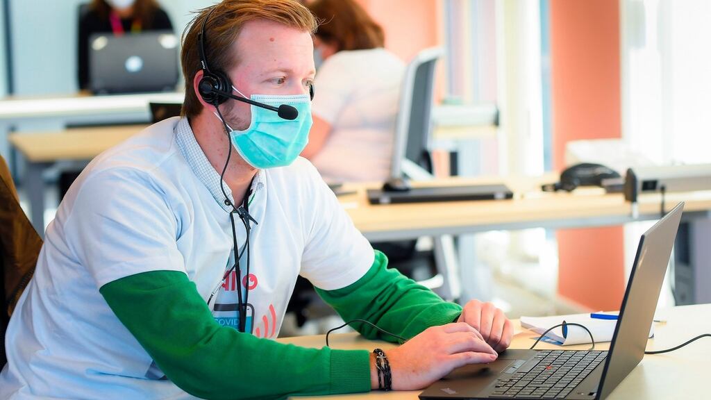 An operator wearing a protective face mask works in a call centre for contact tracing, in Brussels, Belgium. File photograph: Lauria Dieffembacq/Belga/AFP via Getty Images