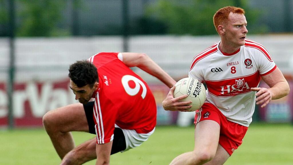 Derry’s Conor McAtamney gives Louth’s James Califf the slip during the All-Ireland SFC Round 1A Qualifier at Owenbeg. Photograph: Lorcan Doherty/Inpho/Presseye