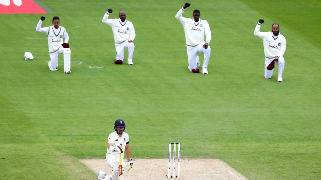 The West Indies and England batsman Rory Burns take the knee at Old Trafford in July. Photograph:   Michael Steele/Getty