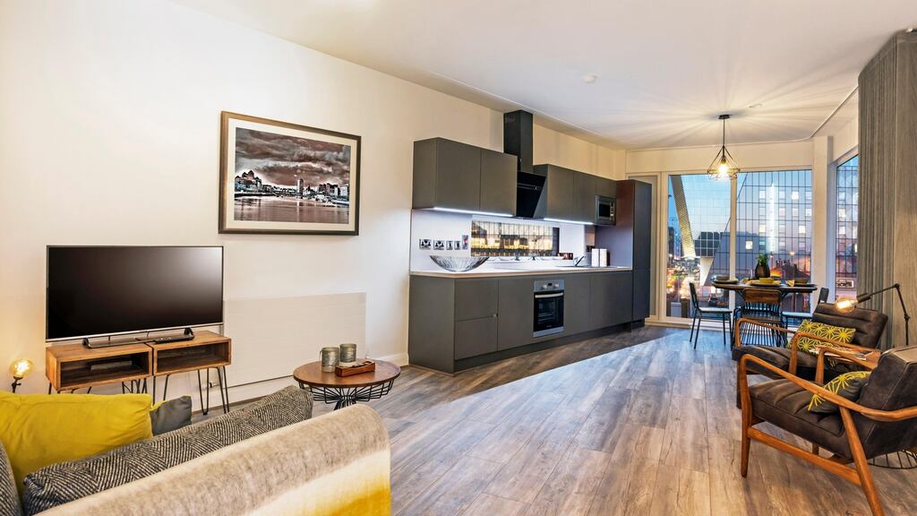 The living space is open-plan, comprising kitchen, dining and lounge areas, with an additional interior study space offering a separate workstation