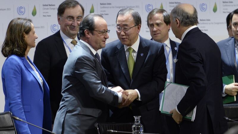 French president Francois Hollande (left) shakes hands with United Nations secretary general Ban Ki-moon (centre) after a statement at the COP21 Climate Conference in Le Bourget, north of Paris, on Saturday. Photograph: AFP