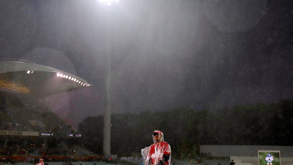 Security guards wearing plastic raincoats stand on the field as rain falls during the second day of the second Ashes cricket test match. David Gray /Reuters