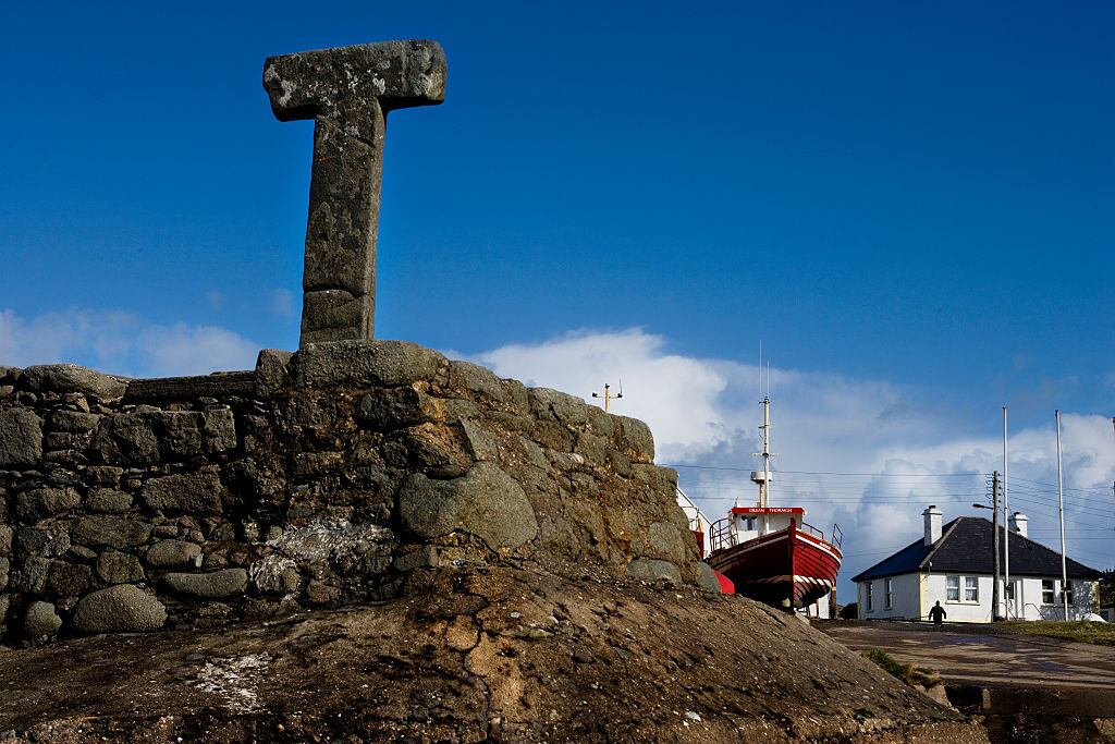 The Tau Cross that overlooks the little harbour at Baile Thiar (West Town) on Tory Island, Co Donegal. One of only four such crosses in Ireland, and by far the largest, it takes its name from a letter of the Greek alphabet. Photograph: Getty Images