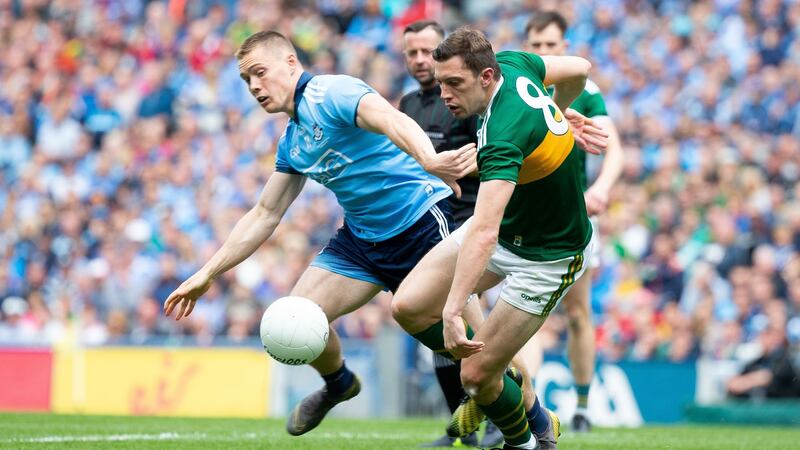 David Moran contests for possession with Con O’Callaghan. Photograph: Tom Honan