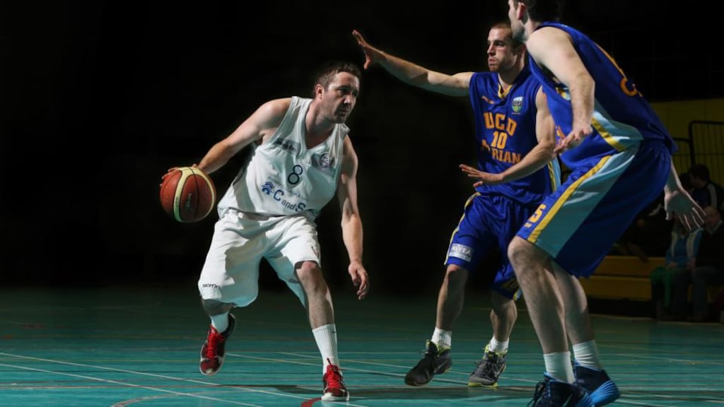 Shane Coughlan of UCC Demons under pressure from Barry Drumm and Neil Baynes of UCD Marian Photograph: Cathal Noonan/Inpho