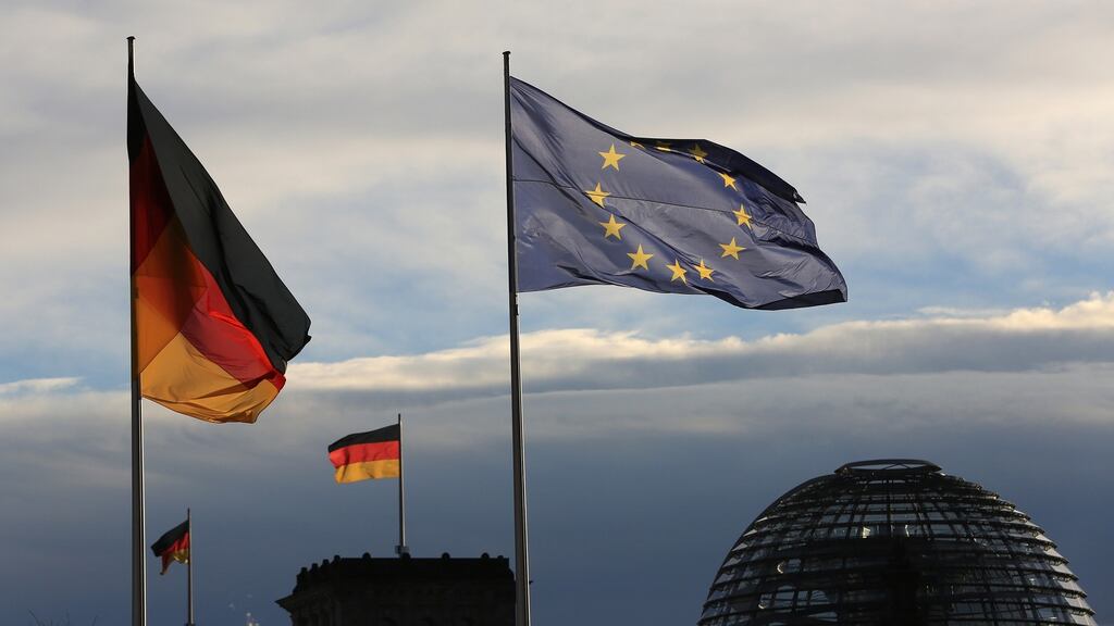 The German national flag flies beside a European Union (EU) flag outside the Chancellery in Berlin. Photograph: Krisztian Bocsi/Bloomberg