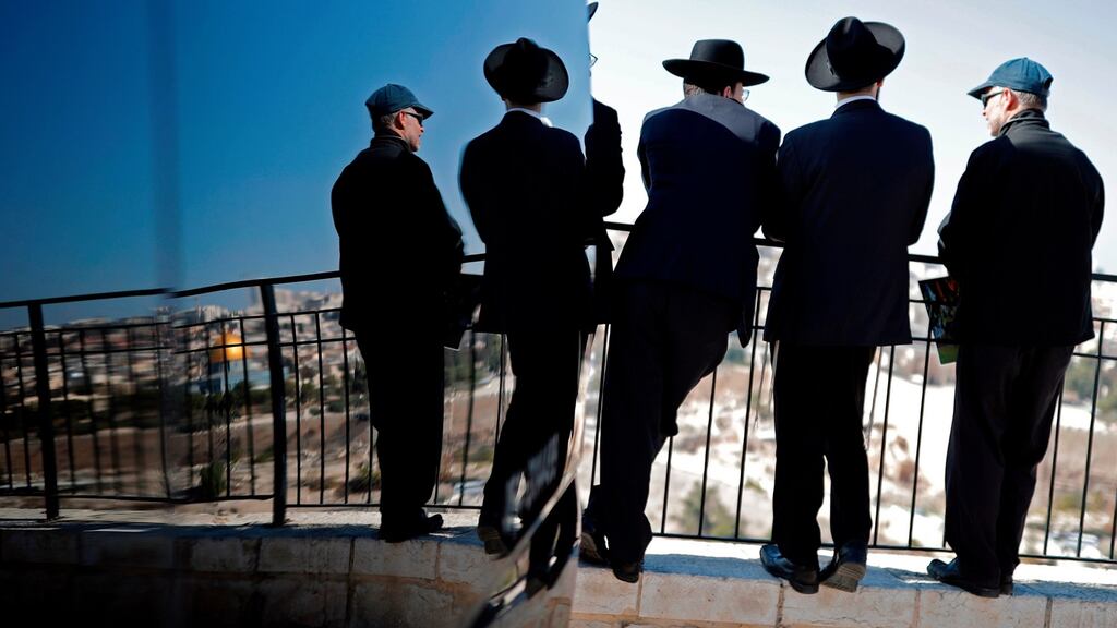 Ultra Orthodox Jews look at the city of Jerusalem from the Mount of Olives. Photograph: Thomas Coex/AFP/Getty Images