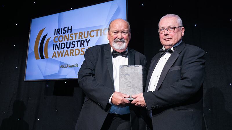 Gerry Wyne, awards judge, presents the Sub-Contractor of the Year award to James McNamara on behalf of LMC Group.