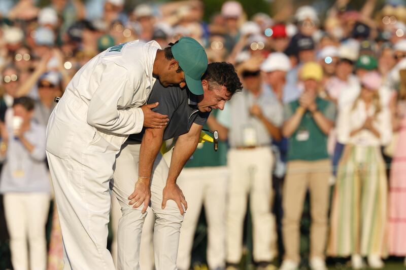 Rory McIlroy embraced by his caddie Harry Diamond after his putt in a playoff round against Justin Rose. Photograph: Erik S Lesser/EPA-EFE