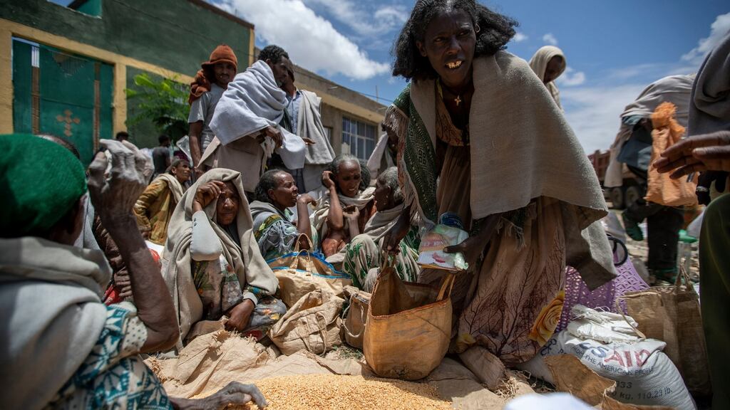 An Ethiopian woman leaves with a portion of yellow split peas distributed by the Relief Society of Tigray in the town of Agula, in the Tigray region of northern Ethiopia. Photograph: Ben Curtis
