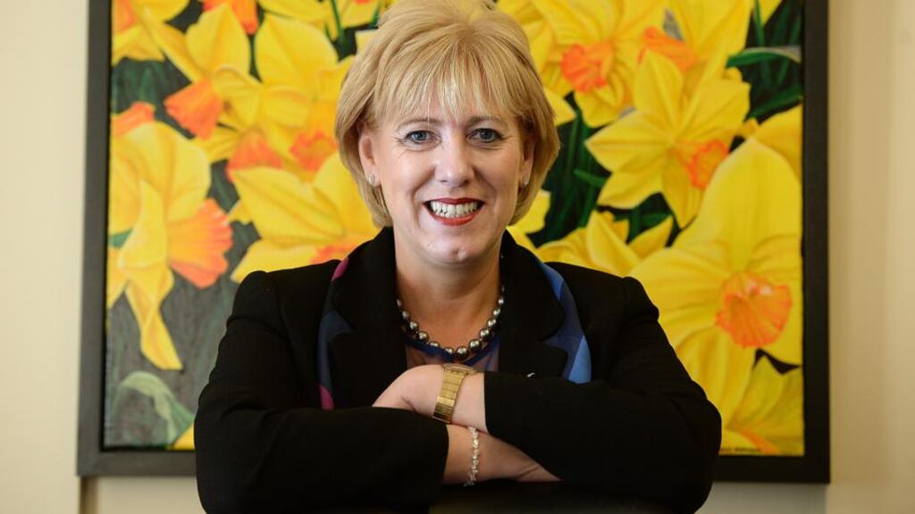 Art at work: Heather Humphreys in her office with a painting by Steven Mannion Farrell. Photograph: Cyril Byrne