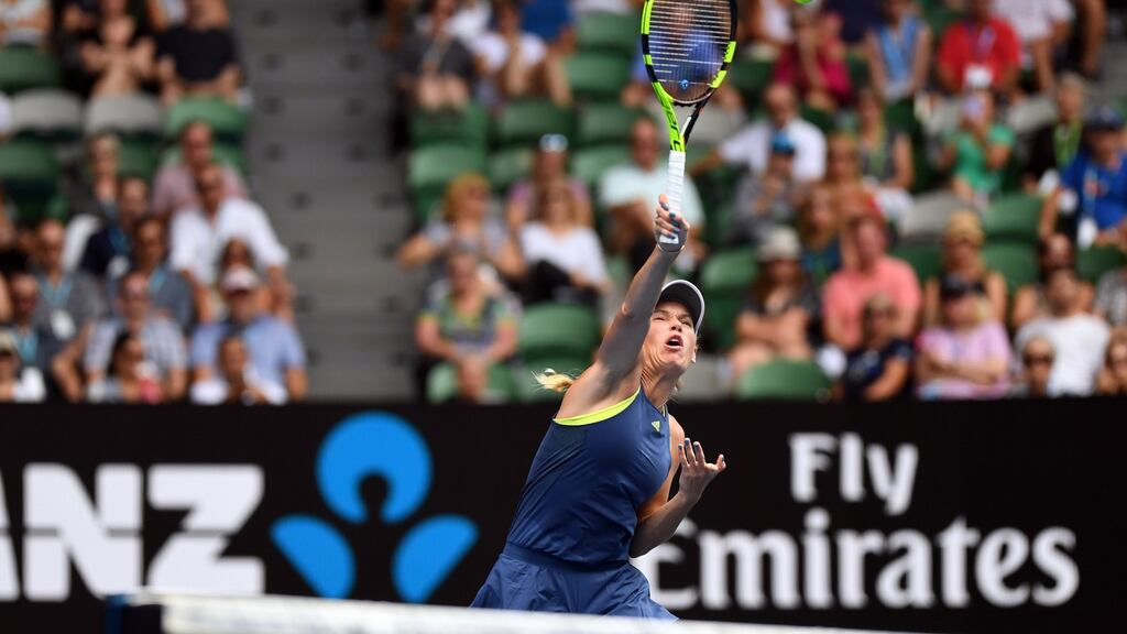 Caroline Wozniacki of Denmark serves against Magdalena Rybarikova of Slovakia during their fourth round clash at the Australian Open. Photo: Dean Lewins/EPA
