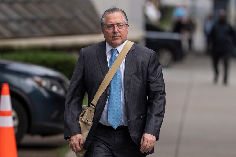 Lead defence lawyer Marc Agnifilo handed his client a piece of paper after the partial verdict development. Photograph: Yuki Iwamura/AP