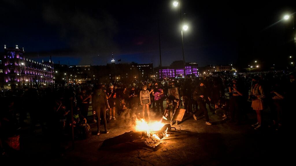 Protesters start a fire in front of the National Palace as they protest during a demonstration to commemorate International Women’s Day in Mexico City, on Monday. Photograph: AFP via Getty Images