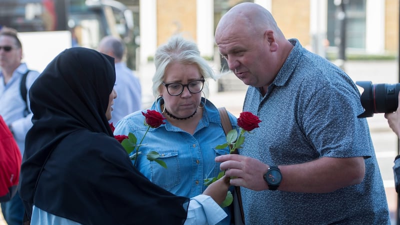 More roses are given out to passers-by on London Bridge.