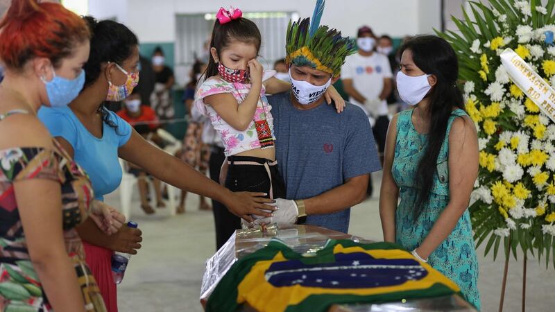 Indigenous from the Parque das Tribos community mourn besides the coffin of Chief Messias (53) of the Kokama tribe who died from coronavirus in Manaus, Brazil. Photograph: Michael Dantas/AFP