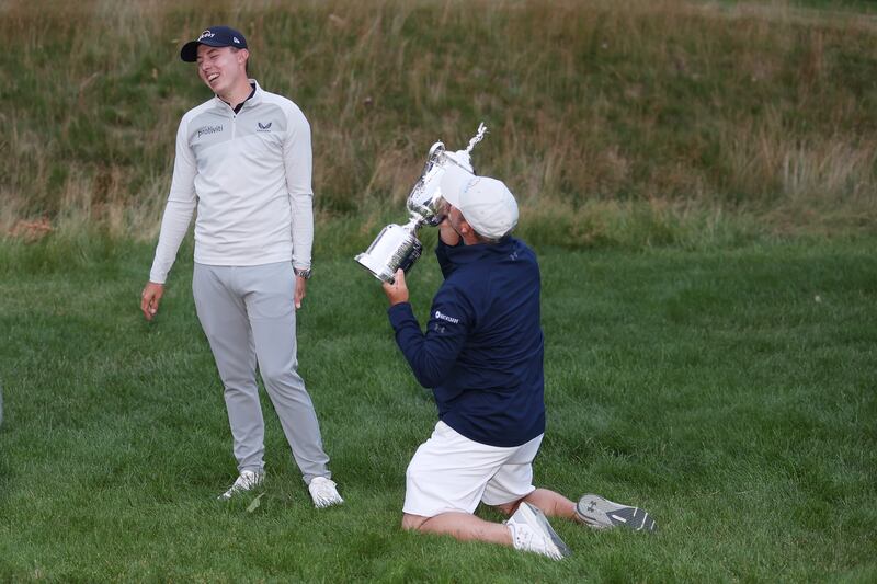 Matt Fitzpatrick of England and caddie Billy Foster celebrate with the US Open trophy at The Country Club in Brookline, Massachusetts. Photograph: