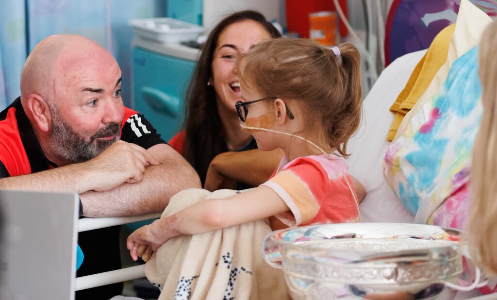 Cork's former manager Matthew Twomey and team captain Amy O'Connor visit Barbara Data, aged 8 from Drogheda, at Temple Street Children's Hospital following their All-Ireland senior final victory over Waterford at Croke Park. Photograph: James Crombie/Inpho
