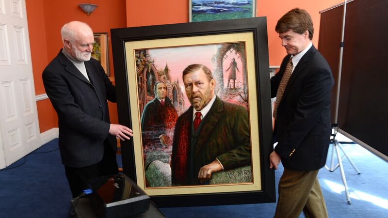 A portrait of Bram Stoker is carried by the artist Aidan Hickey, left, and Stoker’s great-grandnephew, Dacre Stoker. Photograph: Cyril Byrne