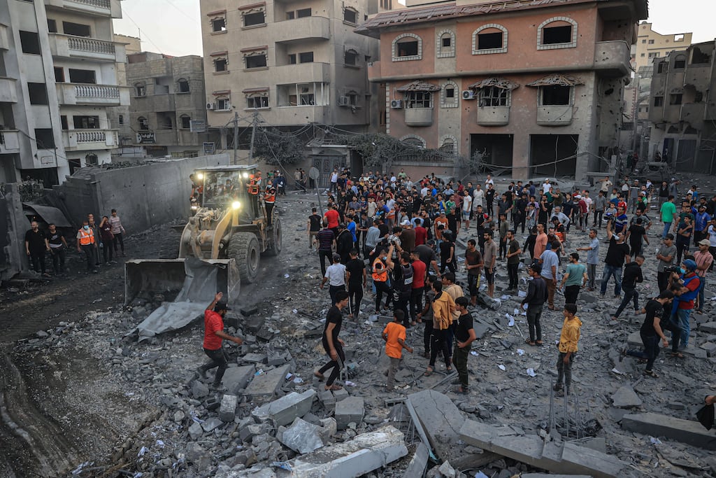 Palestinians gather amid rubble in Rafah in the southern Gaza Strip after it was hit by an Israeli strike on Sunday. Photograph: Said Khatib/AFP