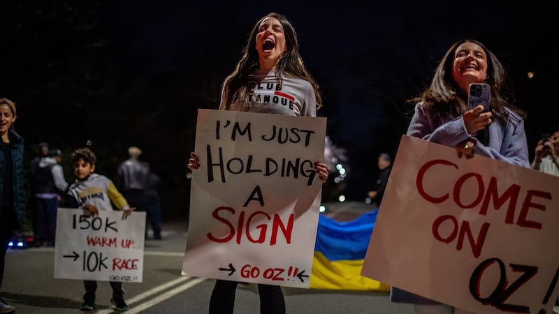 Elisa Rosen, centre, with fans and friends, cheers her husband Oz Pearlman, on his way toward breaking the Central Park loops record. Photograph: Hilary Swift/The New York Times